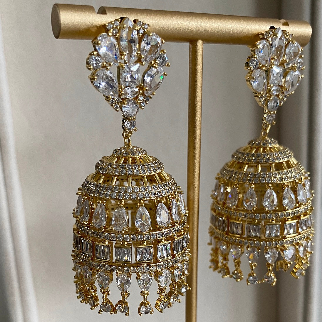 Haifa Crystal Jhumka is a unique combination of traditional and modern design. This jhumka is crafted with cz crystals, making it a luxurious, eye-catching statement piece. With a timeless design and quality construction, this beautiful piece is sure to bring a touch of elegance to any look. Earring drop 6x3cm