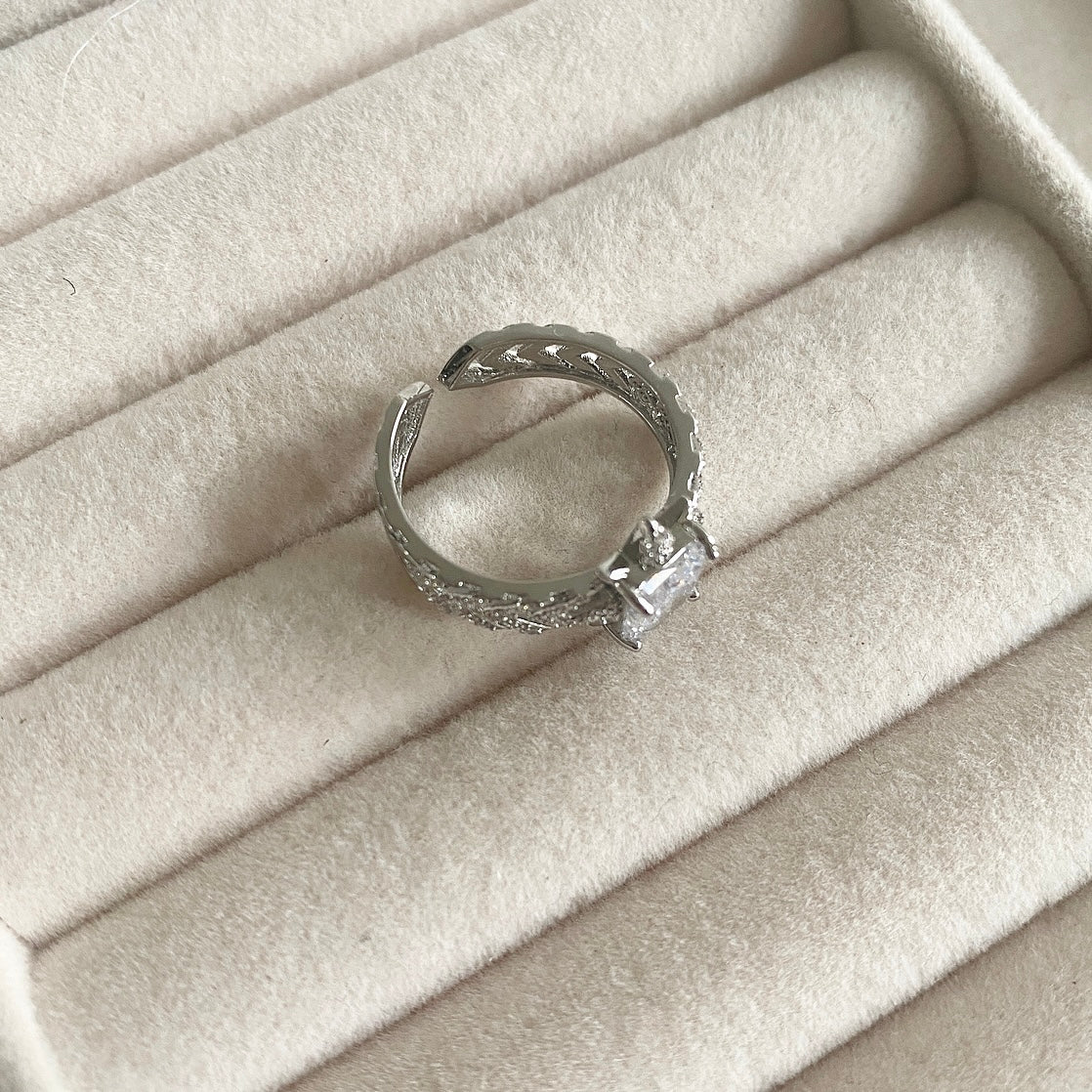 "Transform your look with our Crystal Cut Ring, adorned with sparkling cz crystals. This luxurious piece is both elegant and versatile, with an adjustable size to ensure the perfect fit. Elevate your style and make a statement with this exquisite ring." Adjustable one size.