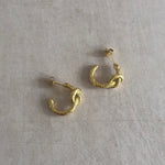 These unique 18k gold-plated earrings feature a textured knot design, perfect for adding a touch of elegance to your look. The delicate, lightweight design ensures all-day comfort. Pair with our coordinating knotted ring for a complete look.