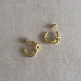 These unique 18k gold-plated earrings feature a textured knot design, perfect for adding a touch of elegance to your look. The delicate, lightweight design ensures all-day comfort. Pair with our coordinating knotted ring for a complete look.