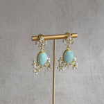 Elevate your jewelry collection with the Jessie Jade Crystal Drop Earrings. These stunning earrings feature amazonite gemstones and sparkling cubic zirconia, adding a touch of elegance and glamour to any outfit. Transform your look with the natural beauty of these earrings.