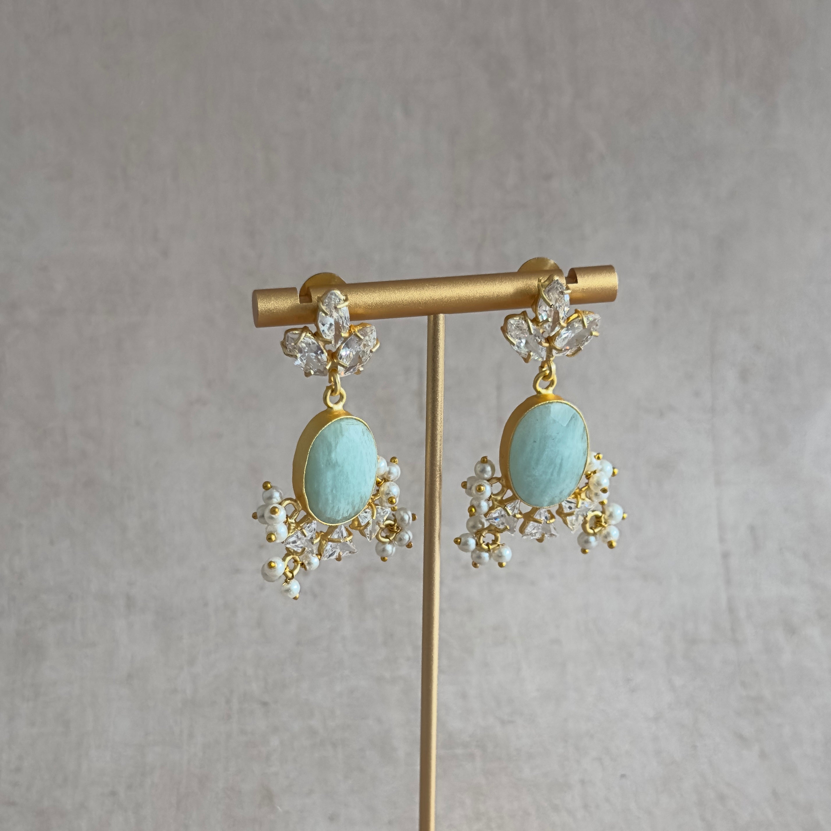 Elevate your jewelry collection with the Jessie Jade Crystal Drop Earrings. These stunning earrings feature amazonite gemstones and sparkling cubic zirconia, adding a touch of elegance and glamour to any outfit. Transform your look with the natural beauty of these earrings.