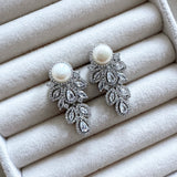 These stunning Hinali Pearl Crystal Earrings are the perfect accessory for any look. Featuring cz crystals for maximum sparkle and shine, a vintage-style, and a pearlescent accent, these earrings are sure to make a statement. Earring drop 3.5cm