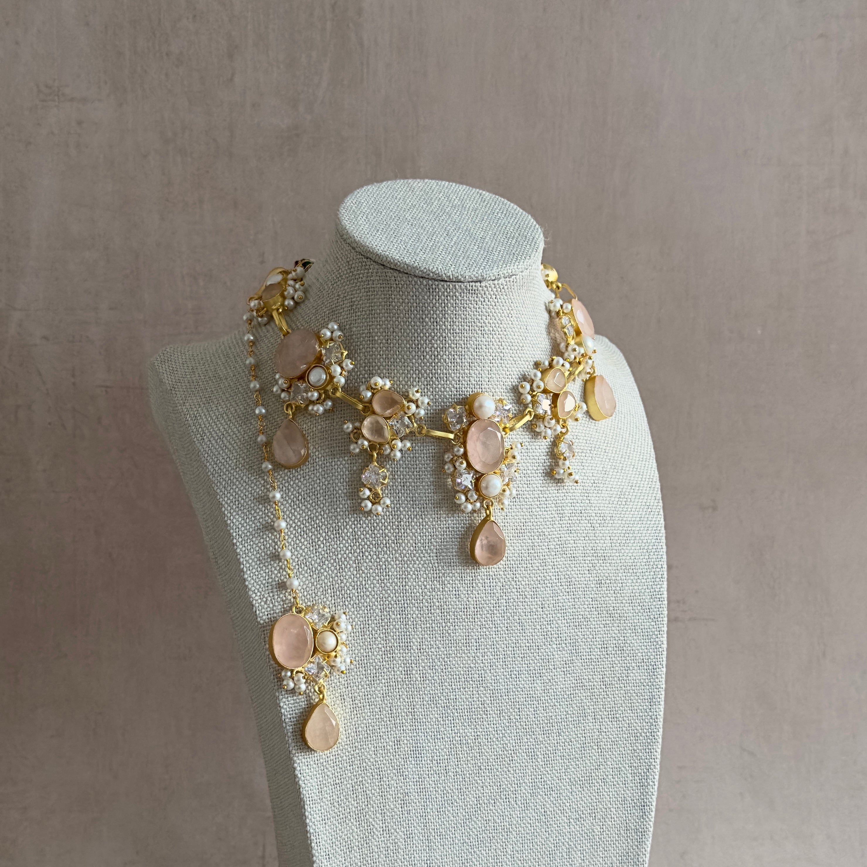 Elevate your style with the Rio Pink Necklace Set. Adorned with rose quartz crystals, freshwater pearls, and sparkling cz crystals, this set adds a touch of elegance to any outfit. The adjustable tie allows for a perfect fit. Perfect for adding a touch of luxury to your wardrobe.