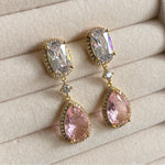 These sparkling Pink Crystal  Earrings, crafted with cz crystals, will add a touch of elegance and sparkle to any ensemble. The exquisite drop earring design and dazzling cubic zirconia crystals will make you shine. Elevate your style and make a stunning statement with these beautiful earrings. Available in a silver & gold finish. Earring drop 4.2cm